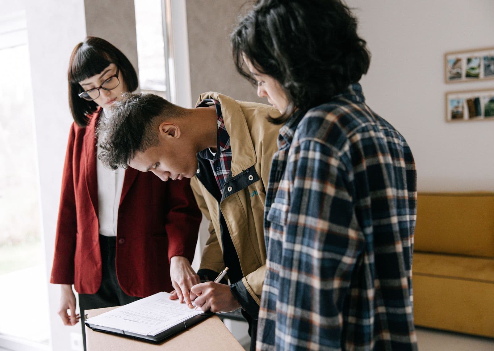 People reading and signing documents at a table