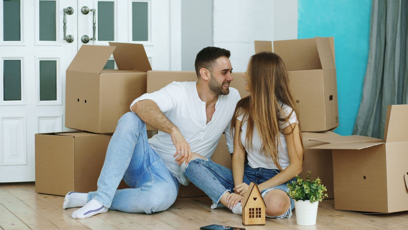 Couple surrounded by packed boxes during a move