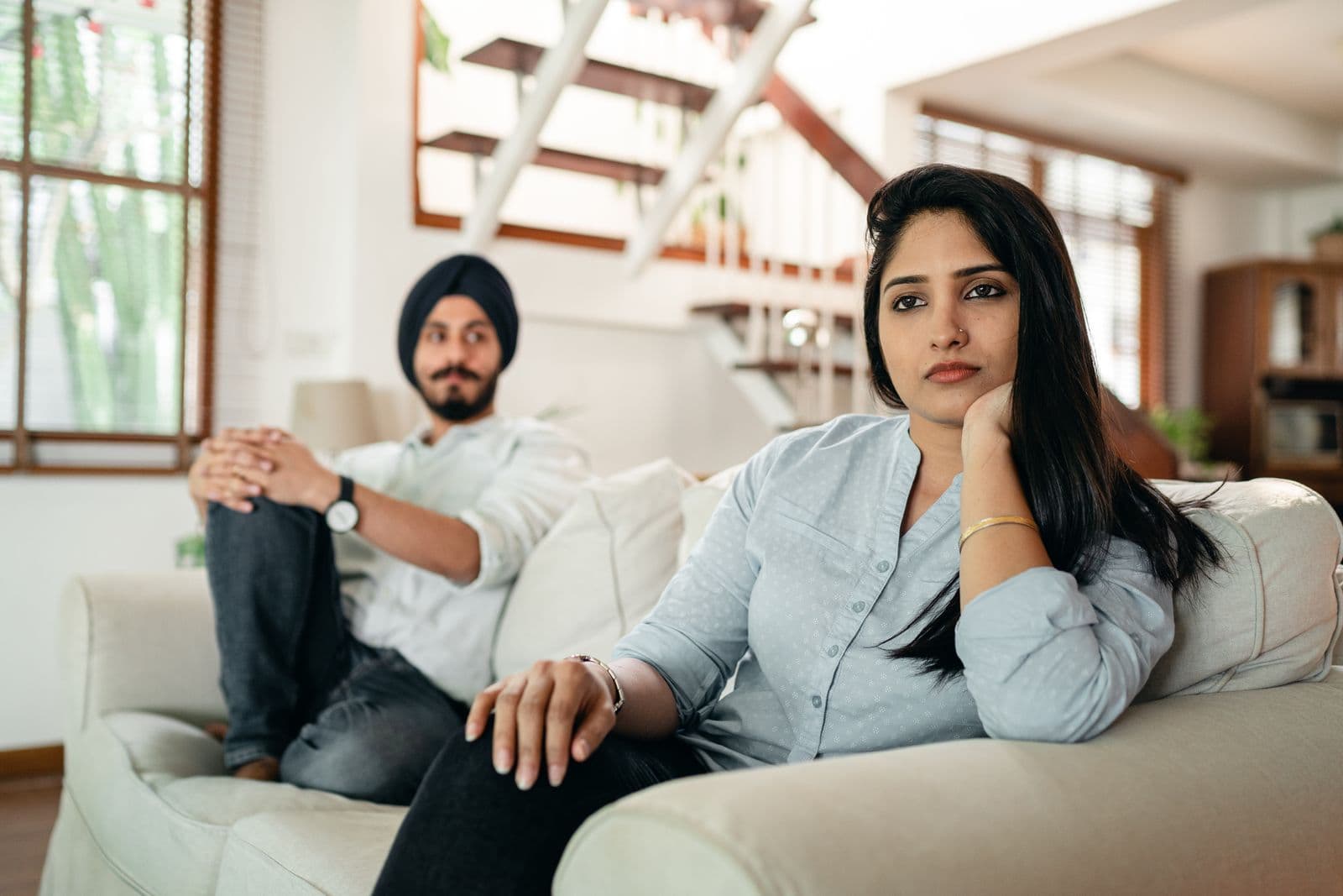 Couple sitting apart during a difficult conversation at home